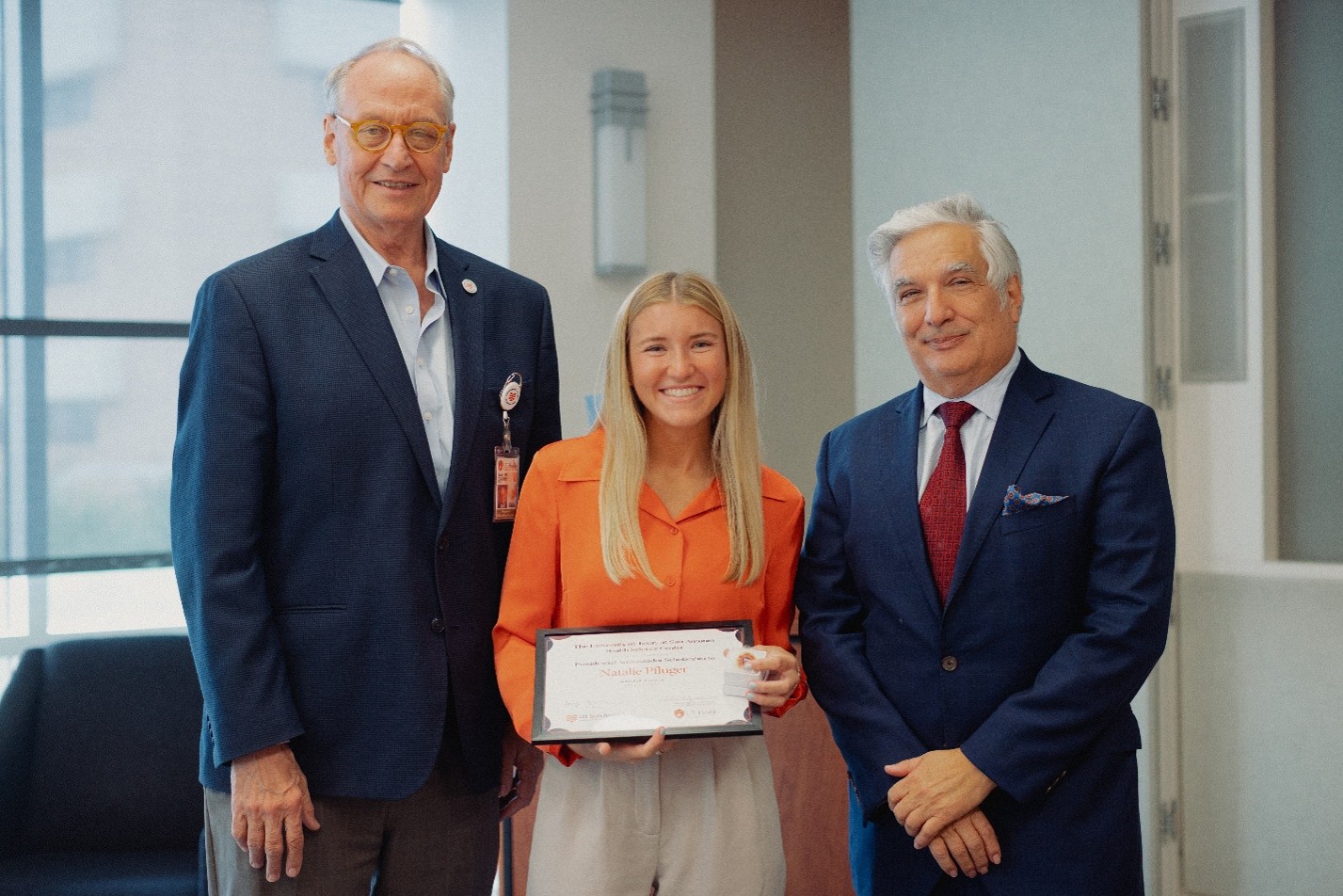 Image of Natalie Pfluger, School of Dentistry Presidential Ambassador scholarship recipient at scholarship luncheon with leadership.