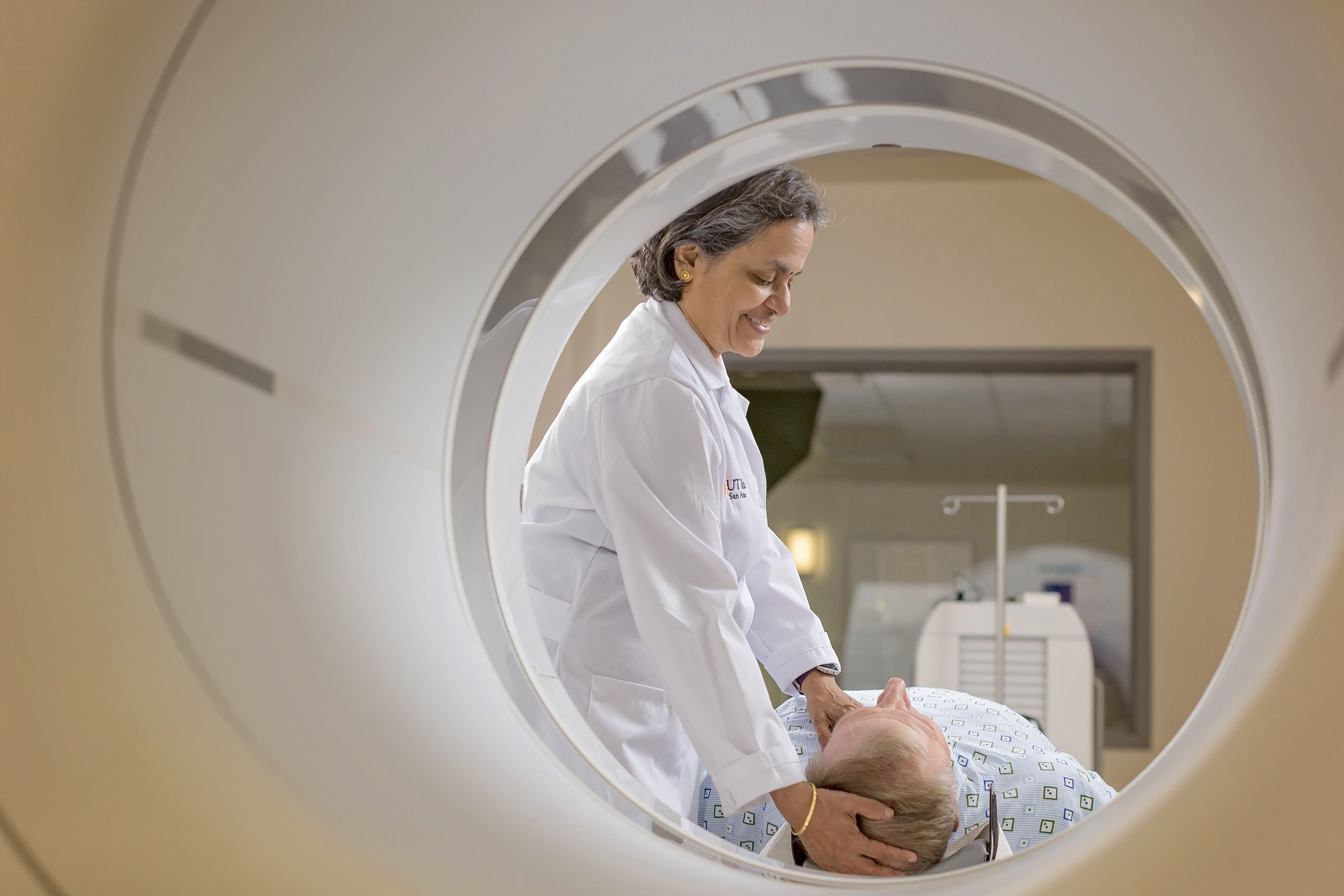 Shuda Seshadri, MD, assisting patient through scanner