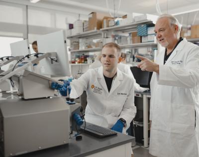 Student Erik Marchant in lab with Professor Rasmussen, PhD