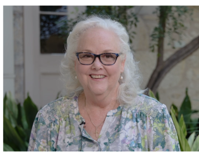 Suzanne Castle smiling during a video interview 