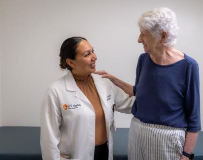 A grateful patient standing beside Dr. Audrie Chavez, Rehabilitation Medicine.