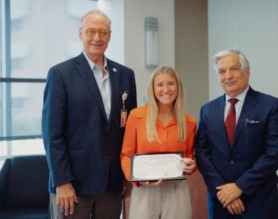 Image of Natalie Pfluger, School of Dentistry Presidential Ambassador scholarship recipient at scholarship luncheon with leadership.