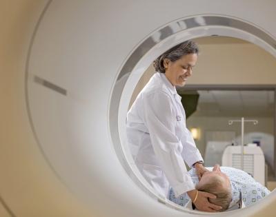 Shuda Seshadri, MD, assisting patient through scanner